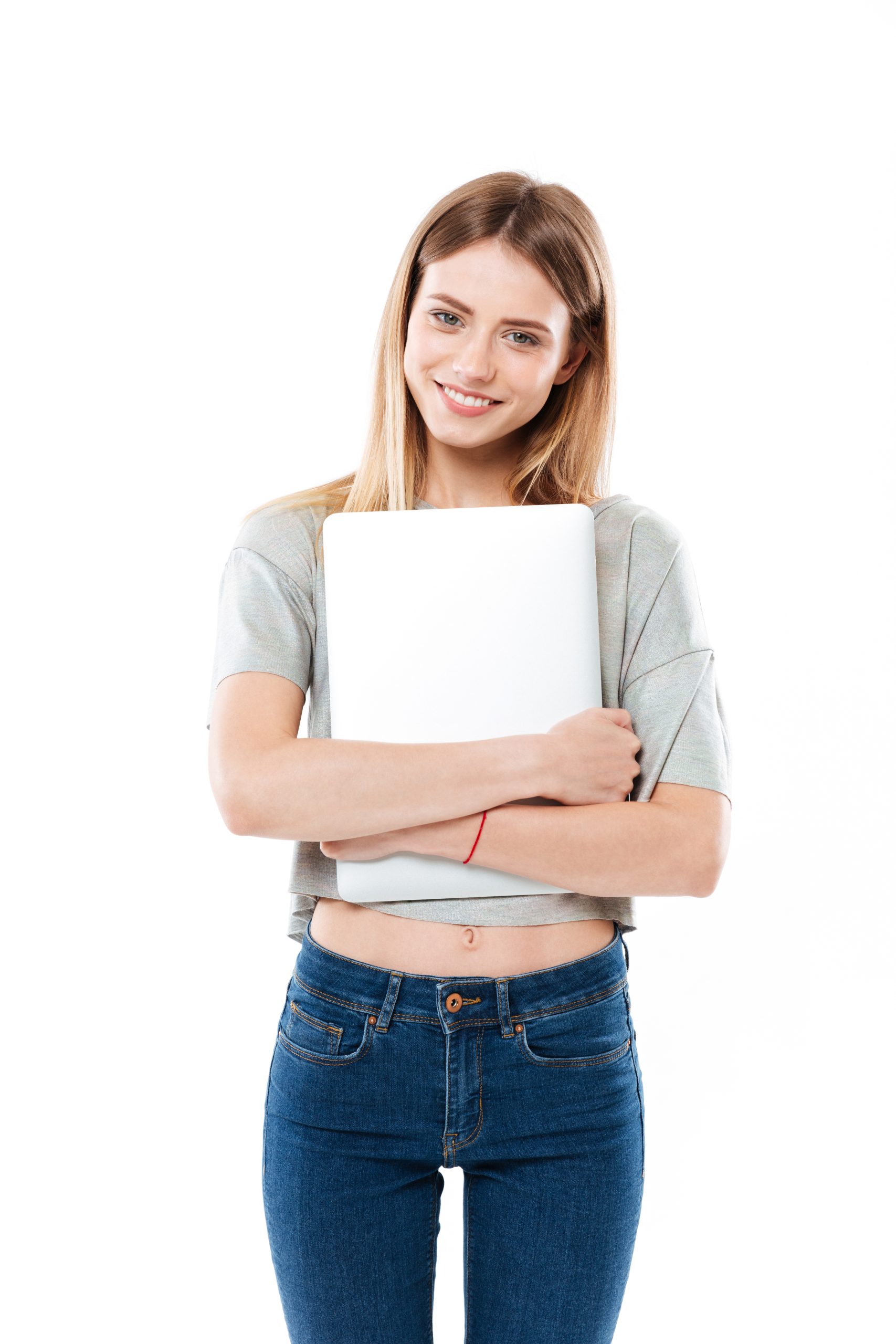 Young woman holding laptop computer Young blonde smiling woman wearing casual clothes holding laptop computer isolated over white